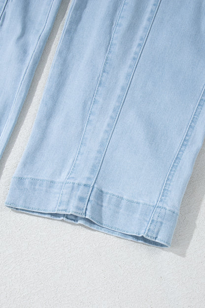 Blue V-neck denim jumpsuit with adjustable straps and pockets