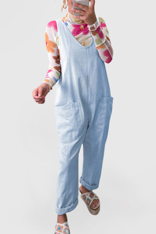 Blue V-neck denim jumpsuit with adjustable straps and pockets