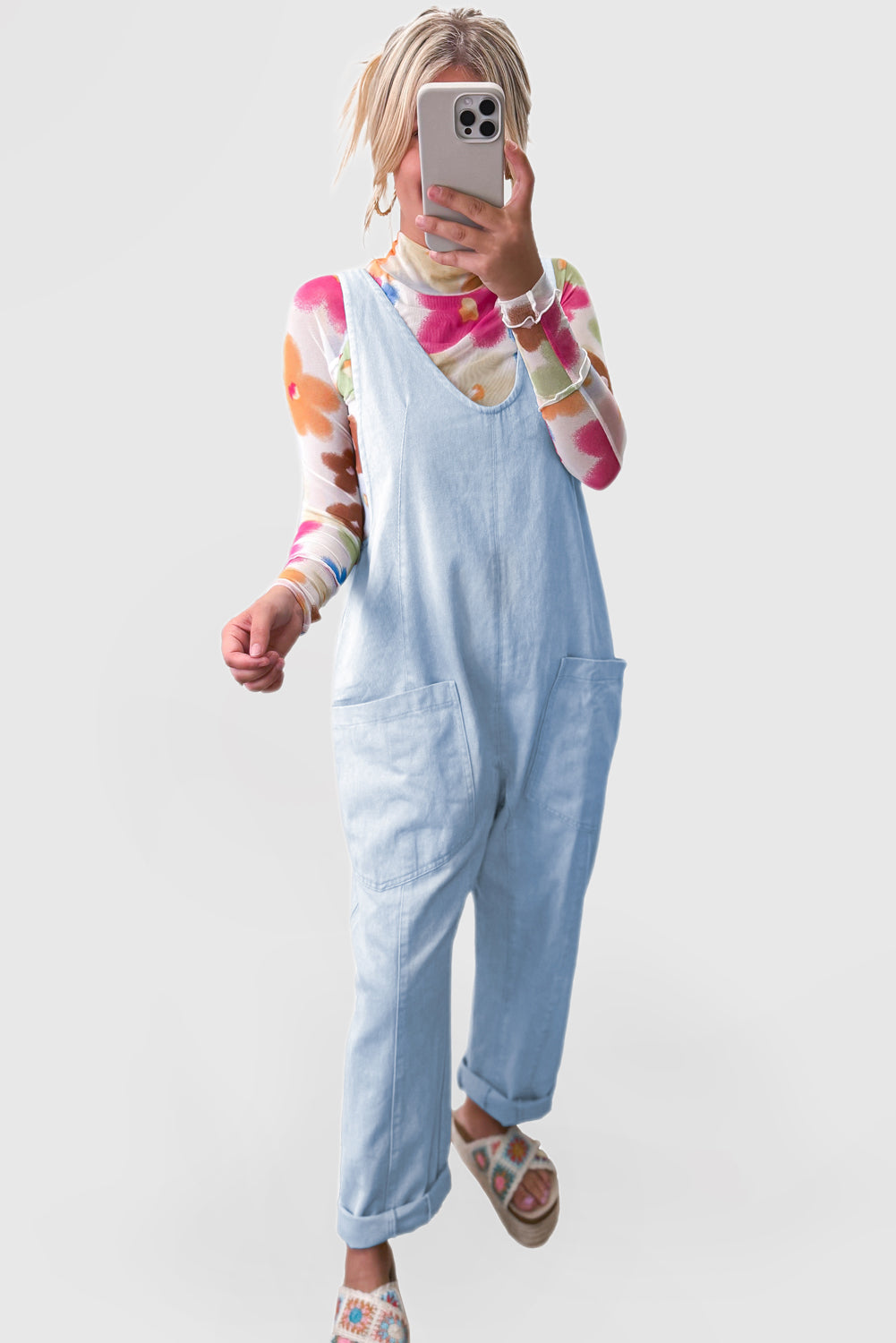 Blue V-neck denim jumpsuit with adjustable straps and pockets