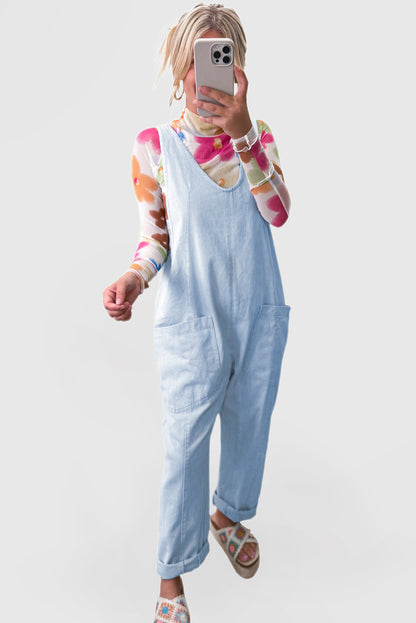 Blue V-neck denim jumpsuit with adjustable straps and pockets