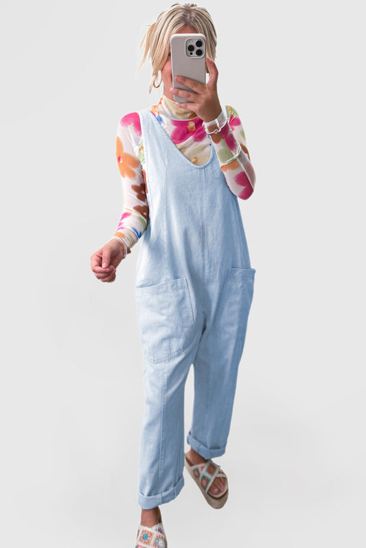 Blue V-neck denim jumpsuit with adjustable straps and pockets