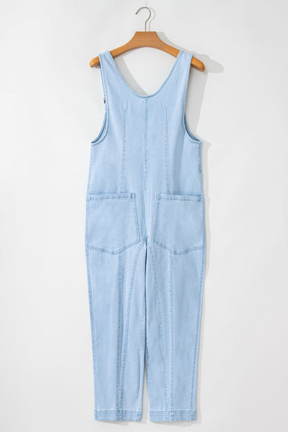 Blue V-neck denim jumpsuit with adjustable straps and pockets