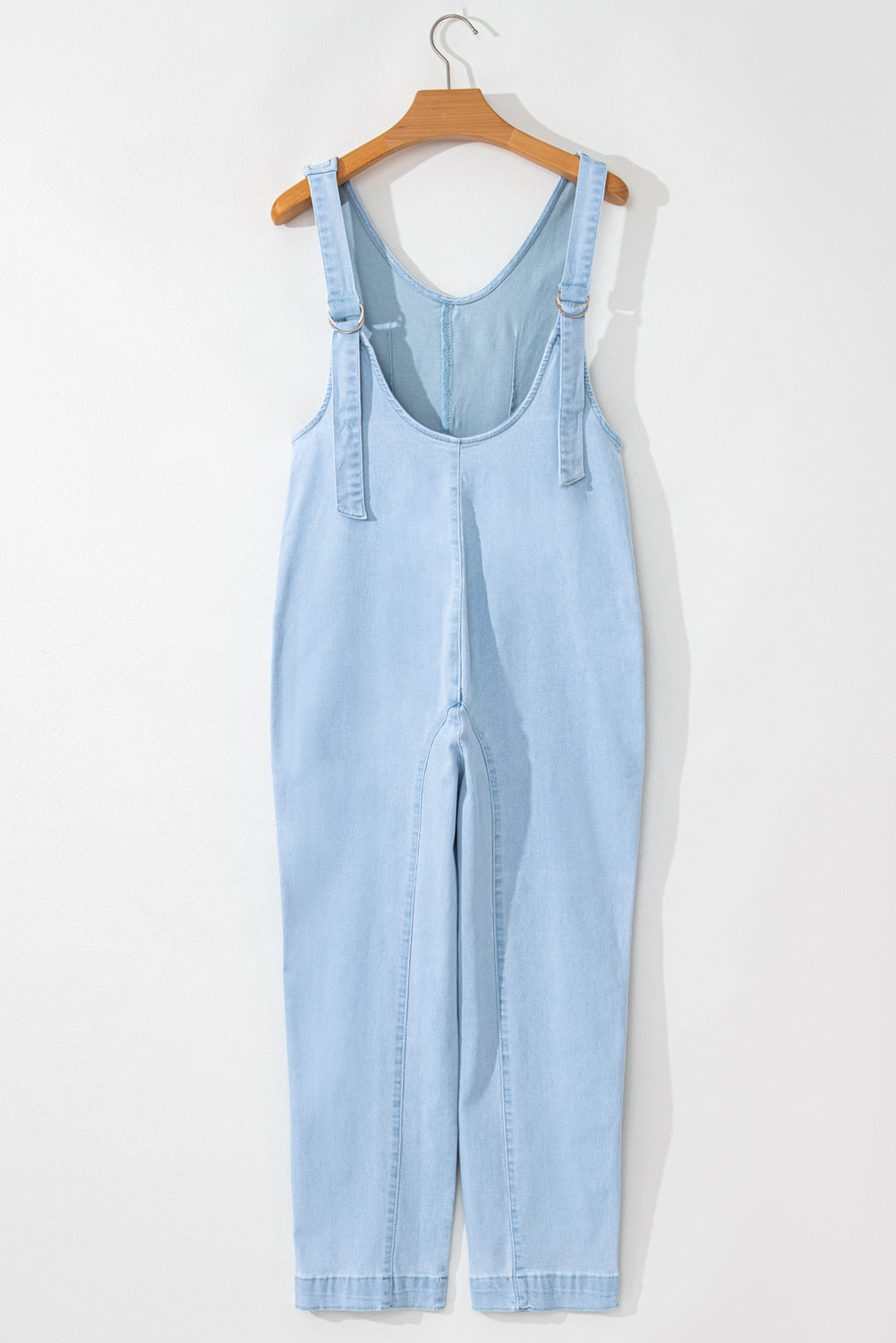 Blue V-neck denim jumpsuit with adjustable straps and pockets
