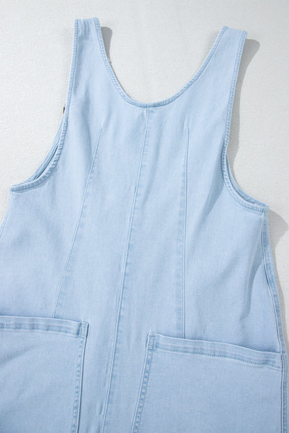 Blue V-neck denim jumpsuit with adjustable straps and pockets