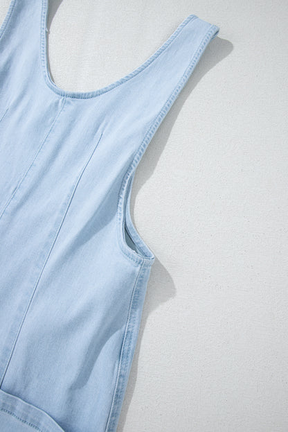 Blue V-neck denim jumpsuit with adjustable straps and pockets