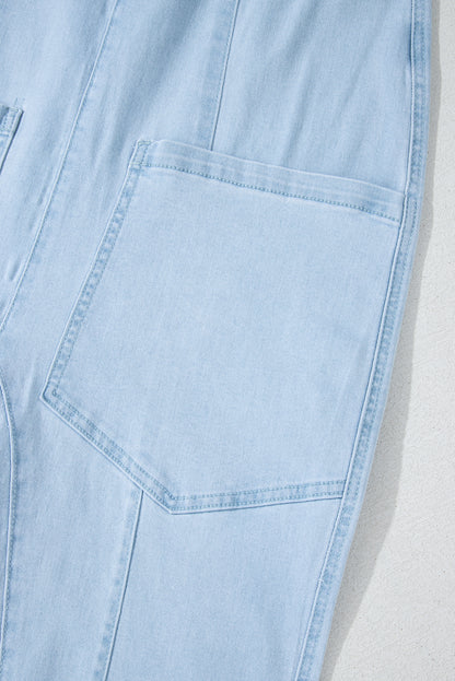 Blue V-neck denim jumpsuit with adjustable straps and pockets